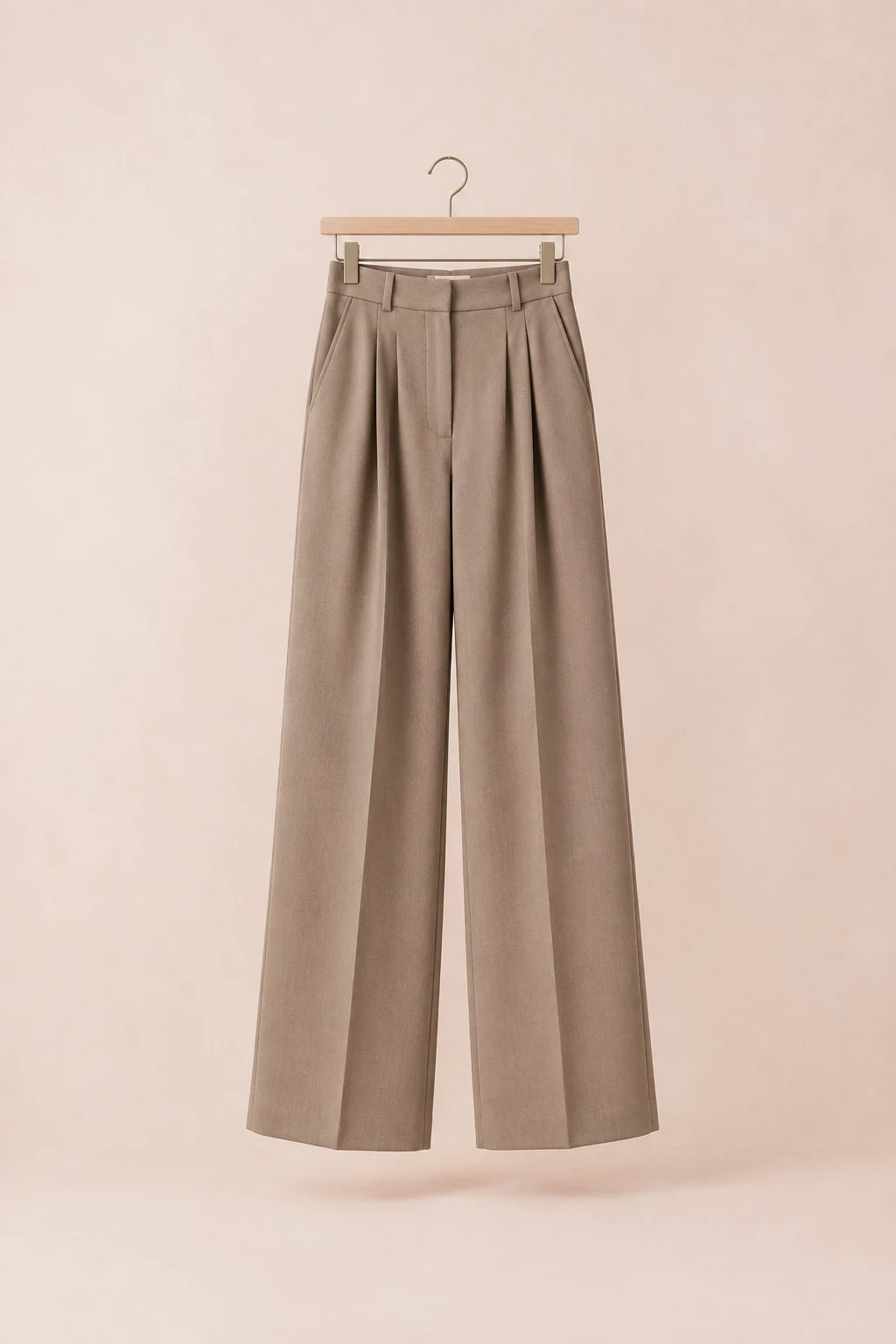 Taupe high-rise wide-leg trousers with pressed creases on a clip hanger